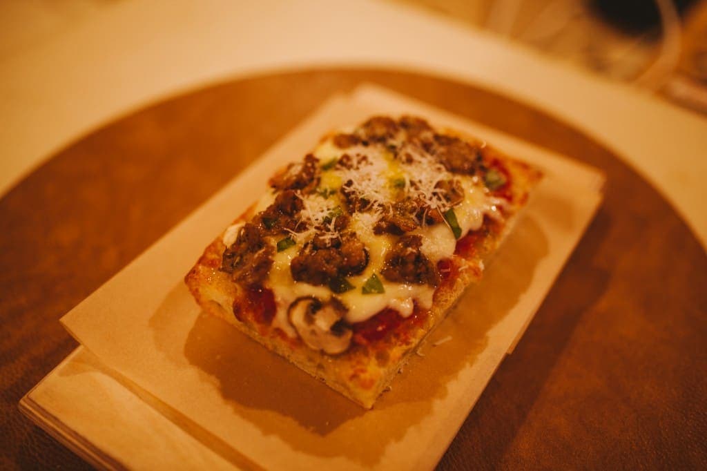 Sausage and mushroom pizza slice at The Analogue Room in Solvang