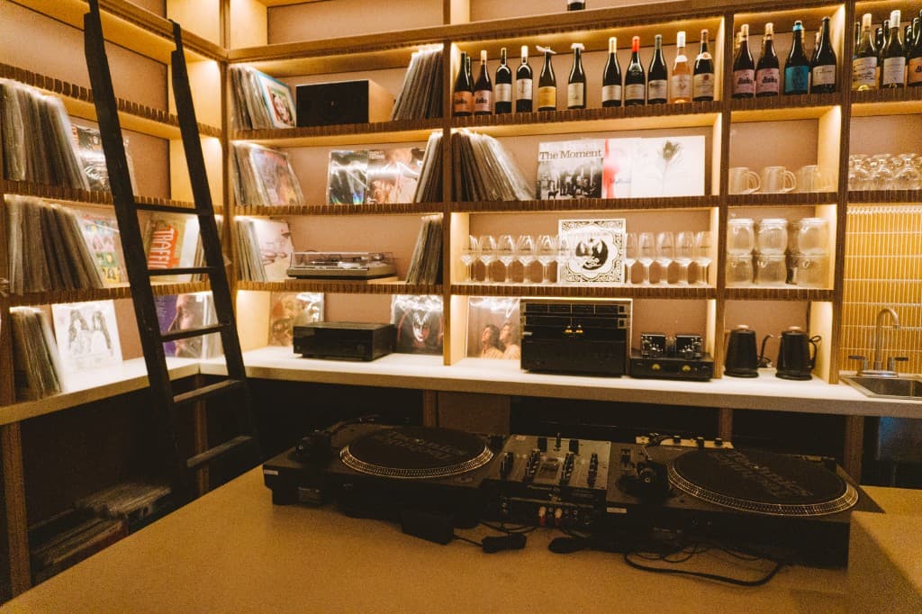 DJ booth and record wall at The Analogue Room bar in Solvang