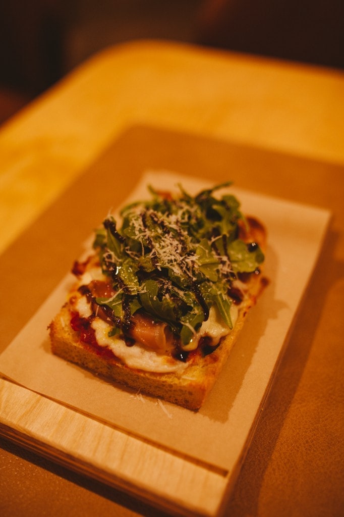 Prosciutto, arugula, and balsamic pizza slice at Analogue Room in Solvang